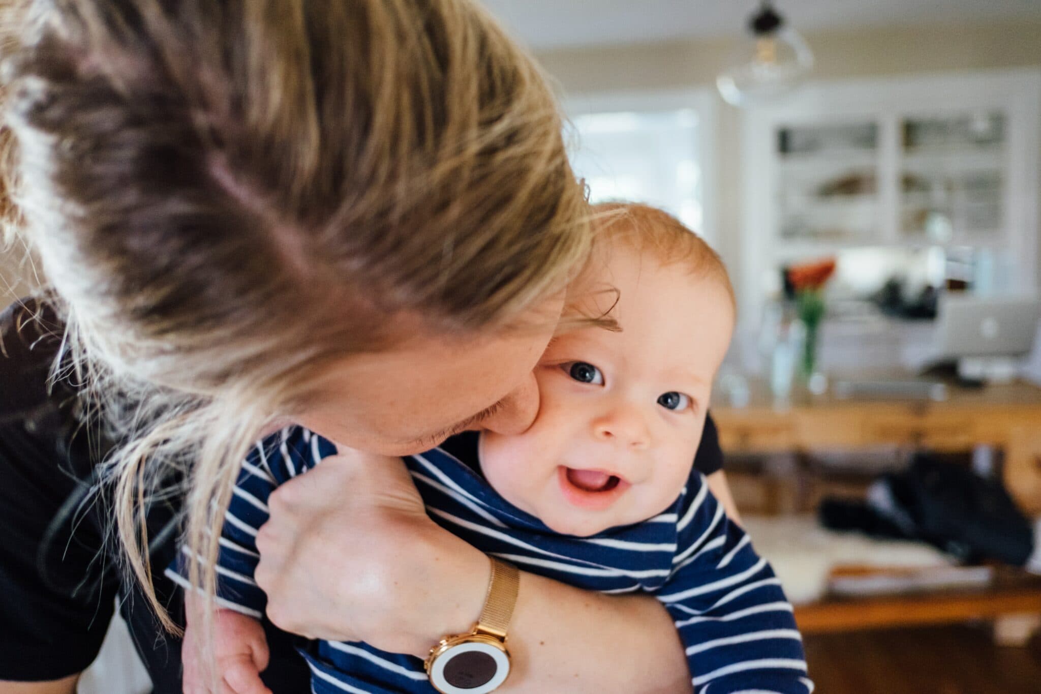 woman holding infant visiting a pediatrician